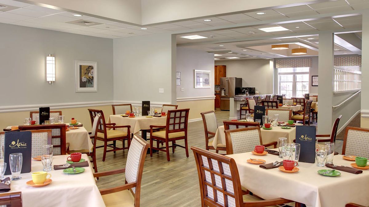 A well-lit dining area with neatly arranged tables and chairs.