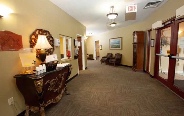 A warmly decorated lobby area featuring elegant furniture and soft lighting.