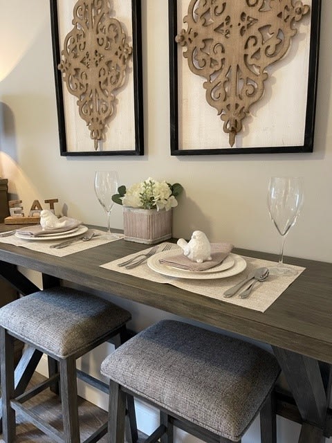 A stylish dining area with a modern table setting and decorative wall art.