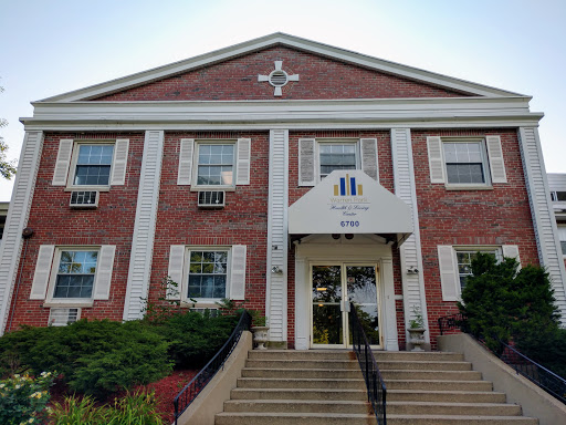 A brick building showcasing traditional architecture with a prominent entrance.