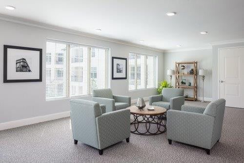 A modern living room with comfortable seating and ample natural light.
