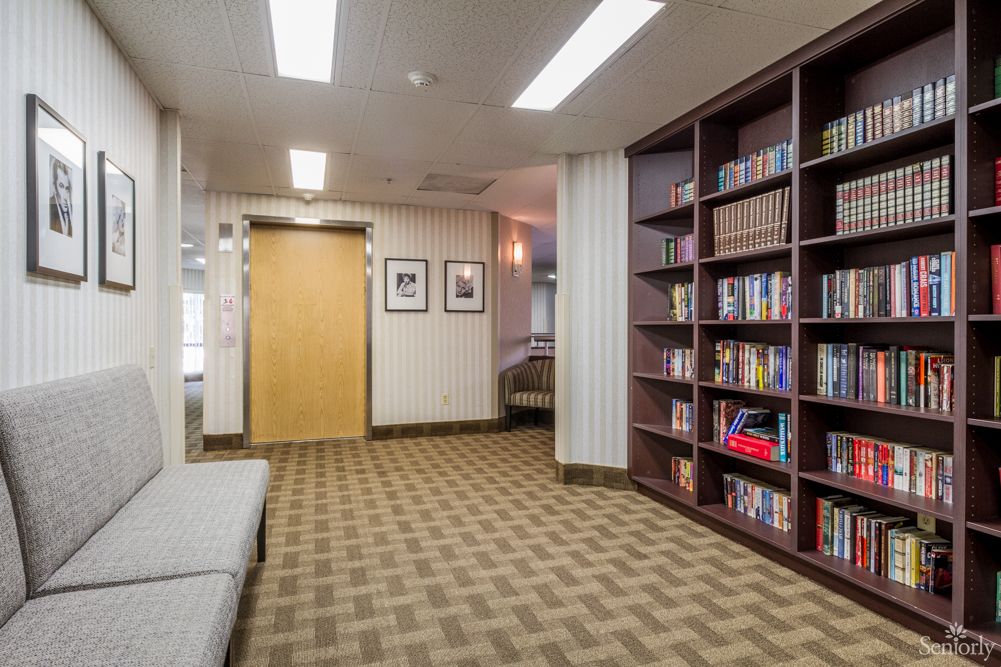 A quiet library reading area with bookshelves and seating.