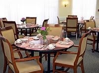 A neatly set dining table with flowers in a restaurant.