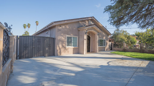 A charming residential house with a welcoming front entrance and sunny surroundings.