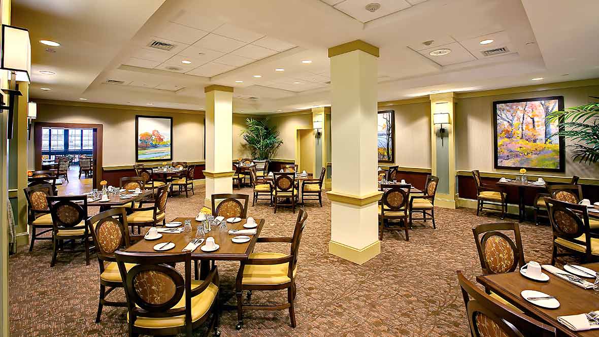 A spacious and well-decorated dining area with tables and chairs arranged neatly.