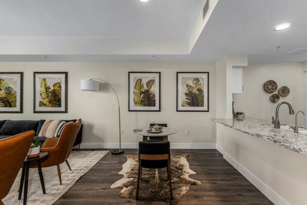 A modern living room with stylish decor and artwork on the walls.