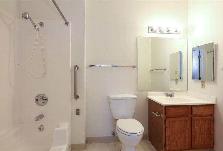 A modern bathroom interior with a toilet, sink, and shower area.