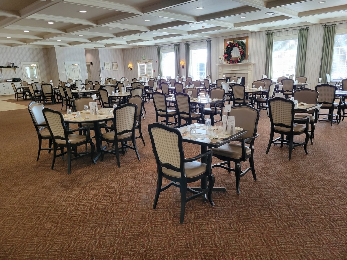 Elegant dining room with neatly arranged tables and chairs.