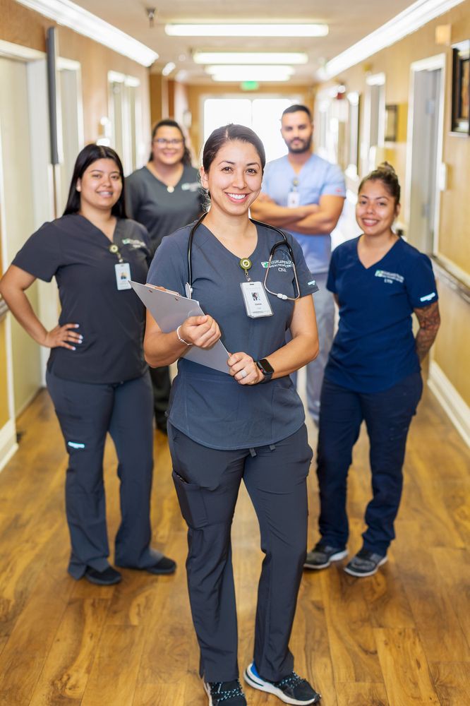 A group of healthcare professionals standing together in a hallway.