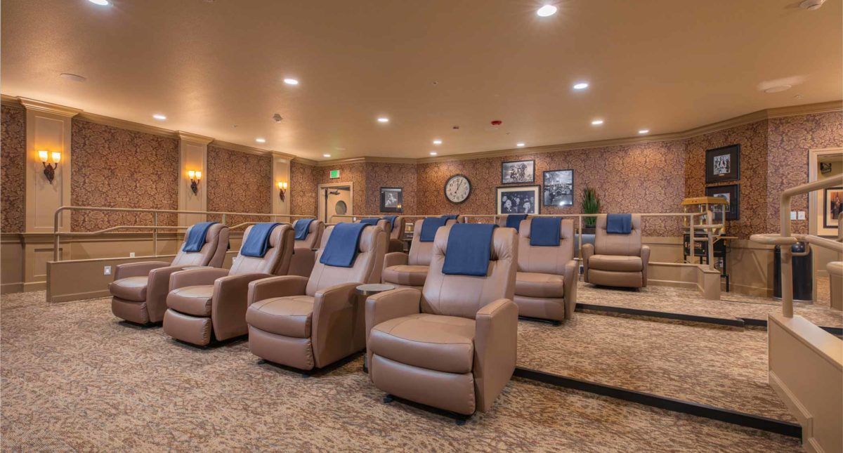 A cozy home theater with rows of recliner seats, perfect for enjoying movies in comfort.
