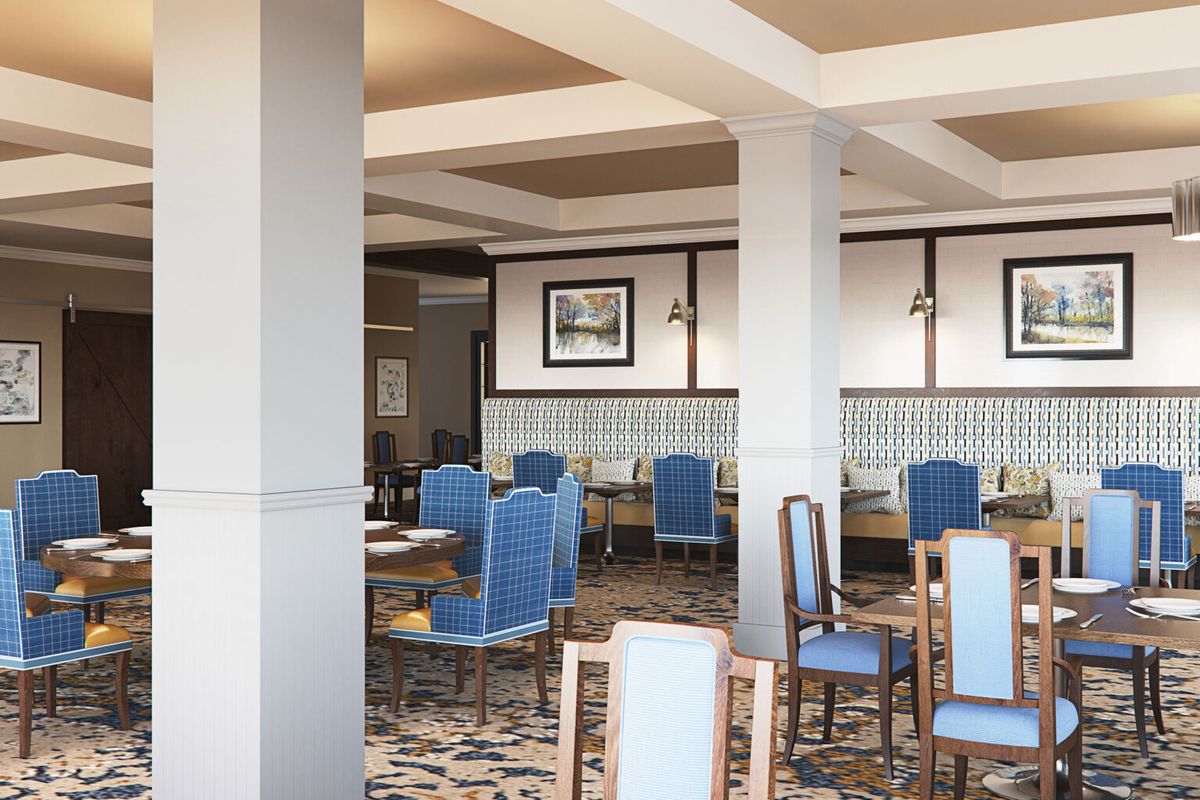 A modern restaurant interior with blue upholstered chairs and neatly arranged dining tables.