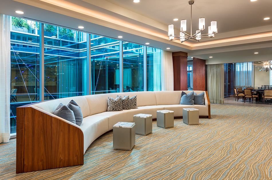 A modern lobby area with curved seating and a large window view.
