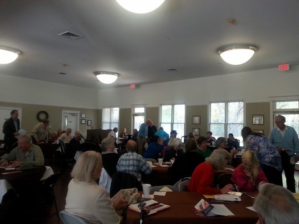 A large group of people gathered indoors for a community event.