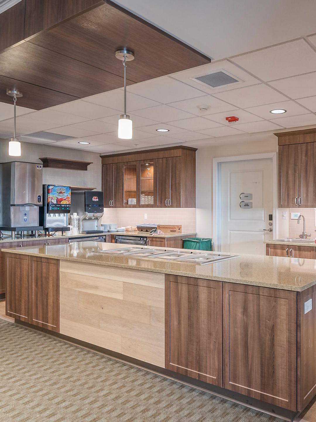 A modern kitchen with wooden cabinets and a large central island.