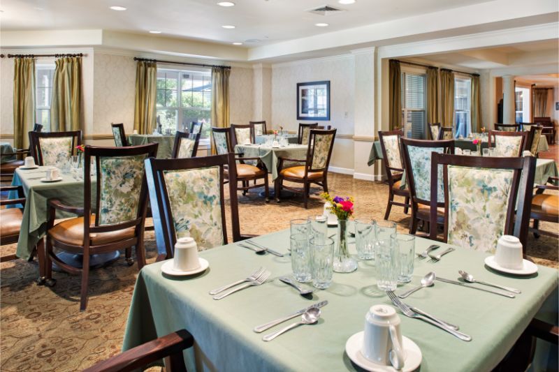 An elegant dining room with neatly arranged tables and chairs, ready for guests.