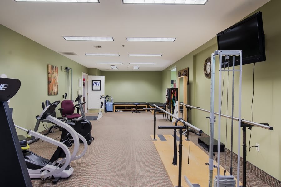 A well-equipped gym with various exercise machines and fitness equipment for workouts.