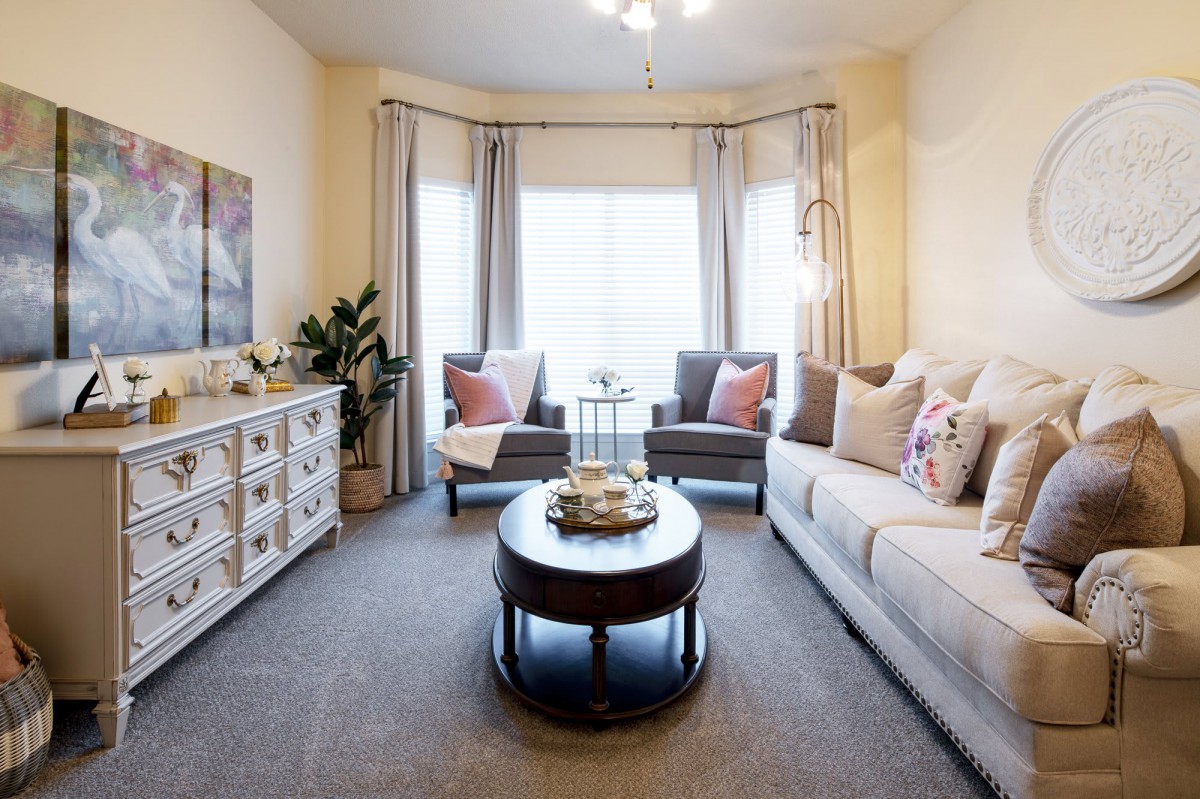 A cozy living room with a comfortable sofa, stylish coffee table, and bright natural lighting.