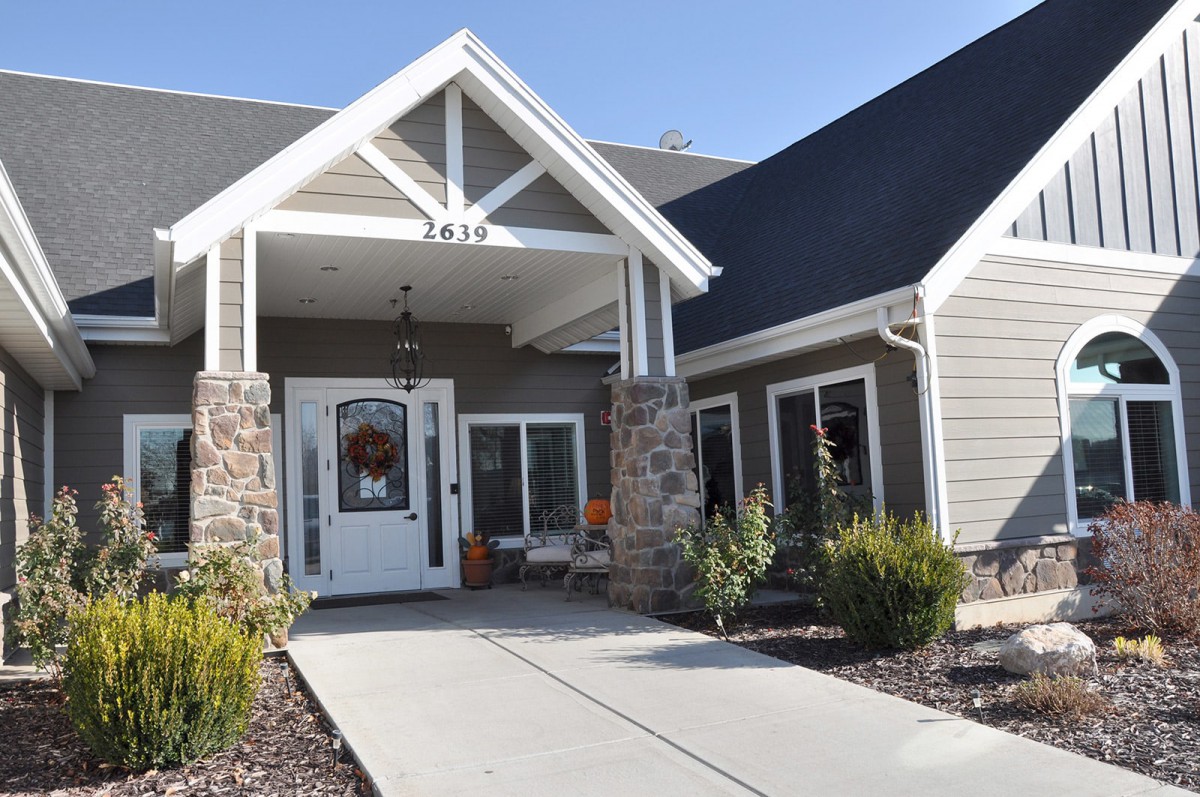 Front view of a modern house with a welcoming entrance and landscaped path.