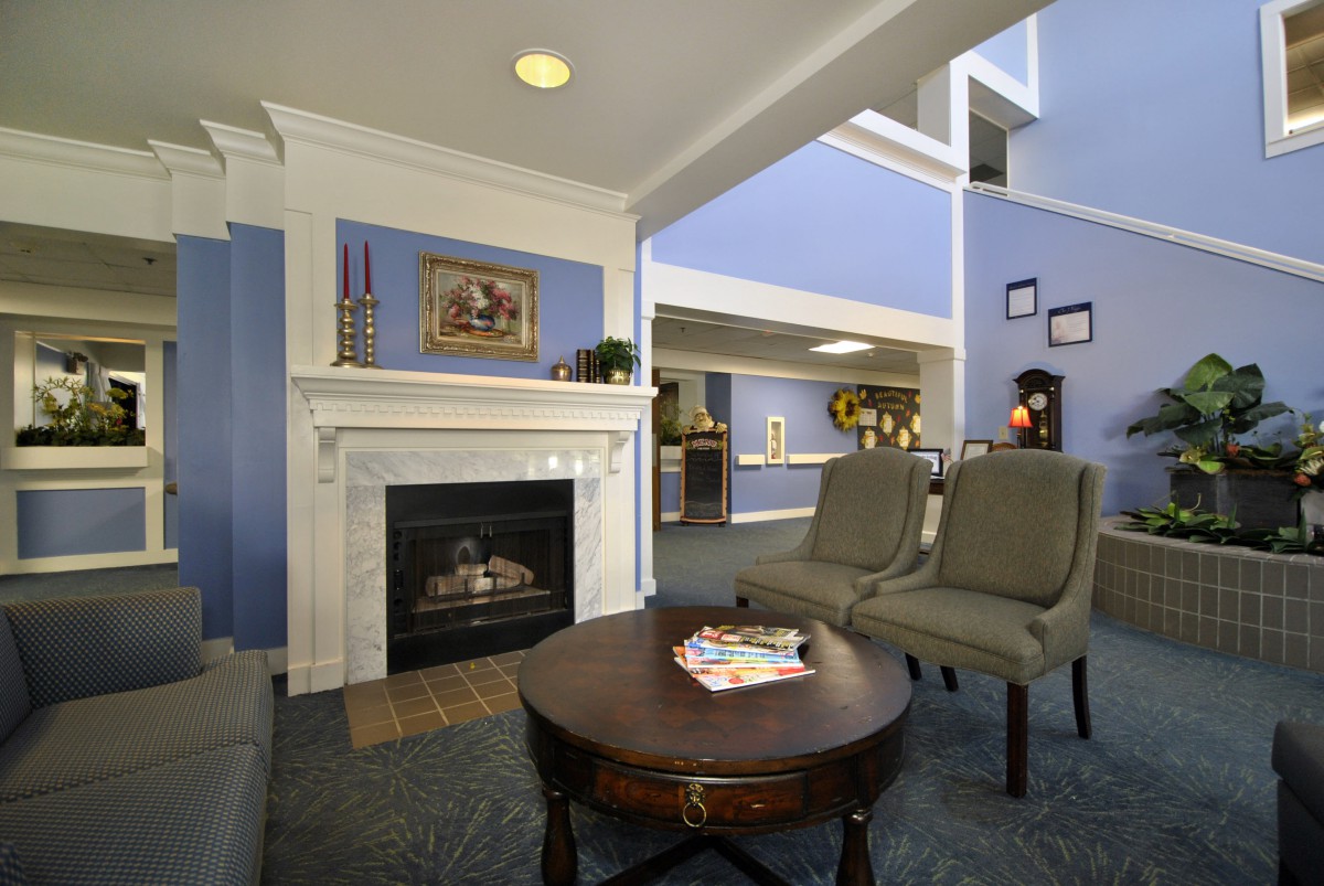 A cozy living room with a fireplace and comfortable seating area.