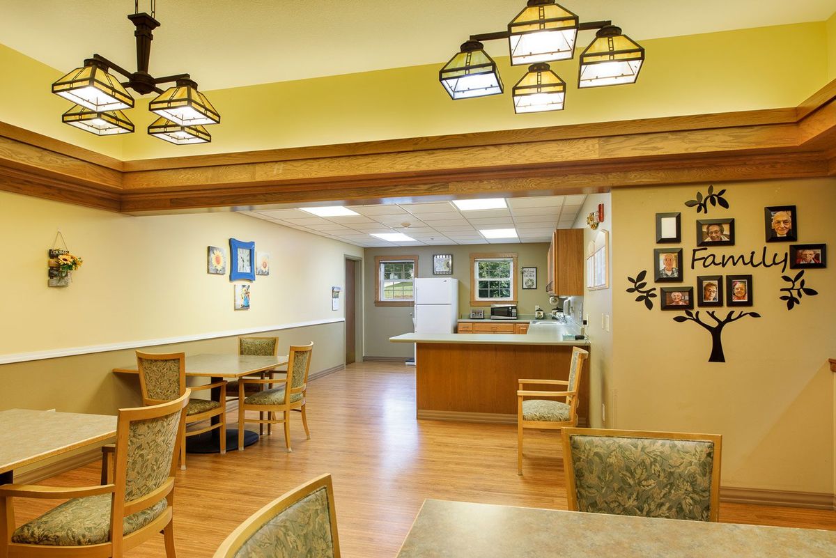 A cozy kitchen and dining area with wooden floors and warm lighting.