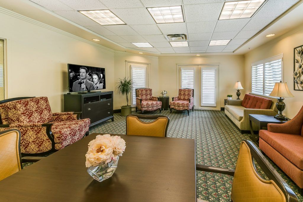 A cozy living room featuring comfortable seating, a television, and elegant decor.