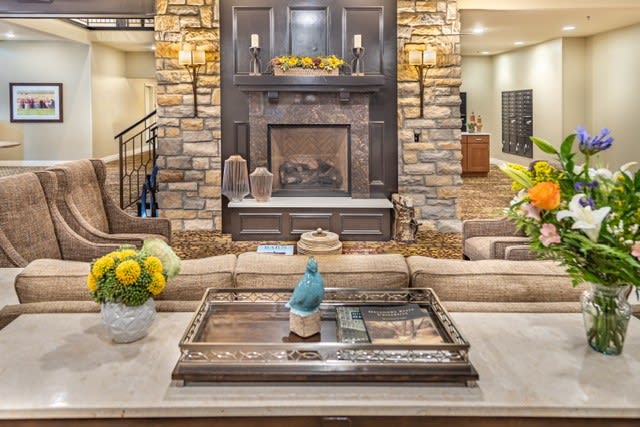 A cozy living room featuring a stone fireplace, stylish sofa, and elegant table decor.