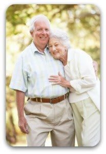 An elderly couple enjoying a moment together outdoors.