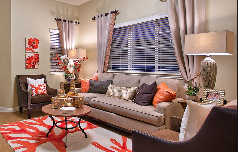 A cozy living room with a comfortable sofa, colorful pillows, and elegant decor.