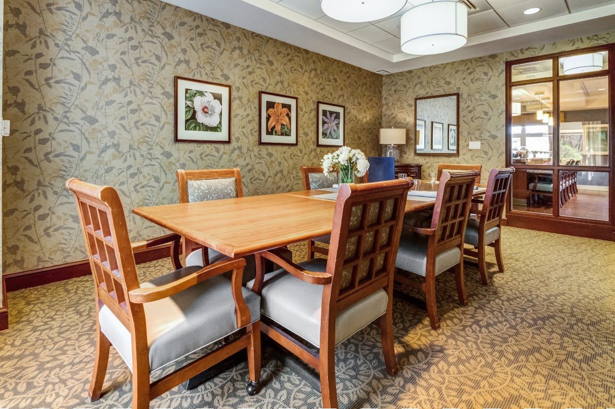Elegant dining room with wooden furniture and decorative artwork on the walls.