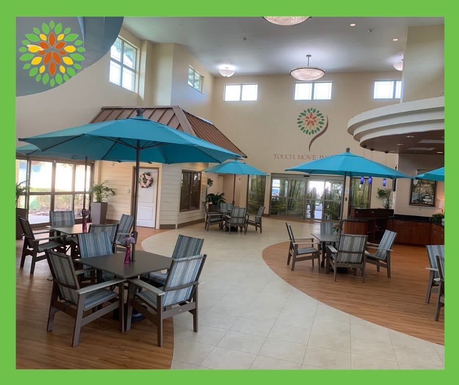 Spacious indoor area with tables, chairs, and umbrellas providing a relaxed atmosphere.