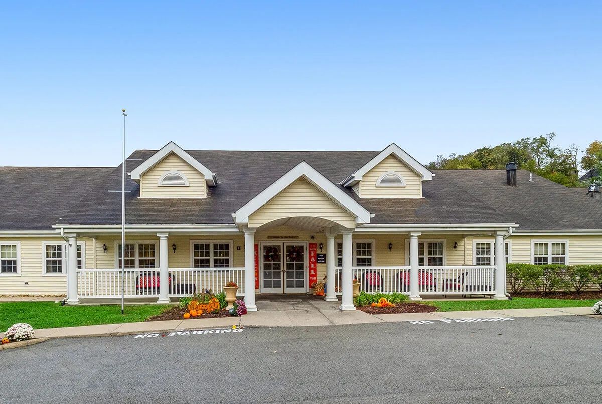 A charming residential building with a welcoming front porch.