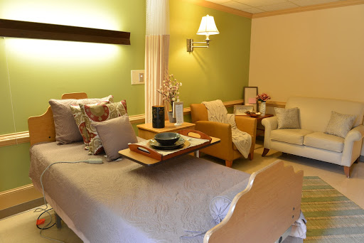 A cozy and colorful bedroom featuring a comfortable bed and inviting sitting area.