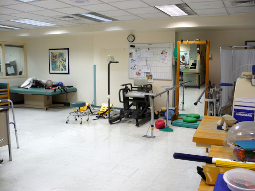 A view of a physical therapy room equipped with various rehabilitation tools.