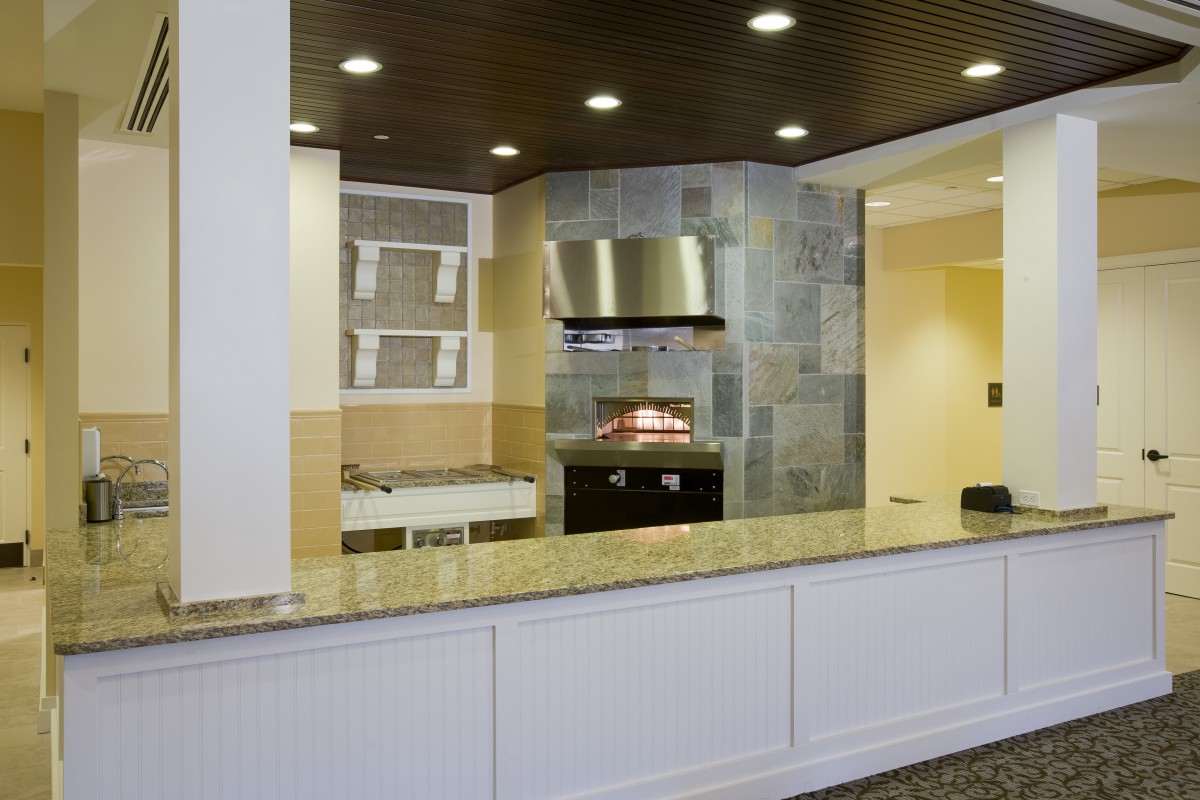 A modern kitchen with a sleek countertop and stainless steel appliances.