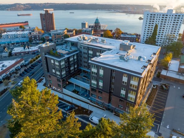 Aerial view of urban buildings near a waterfront.