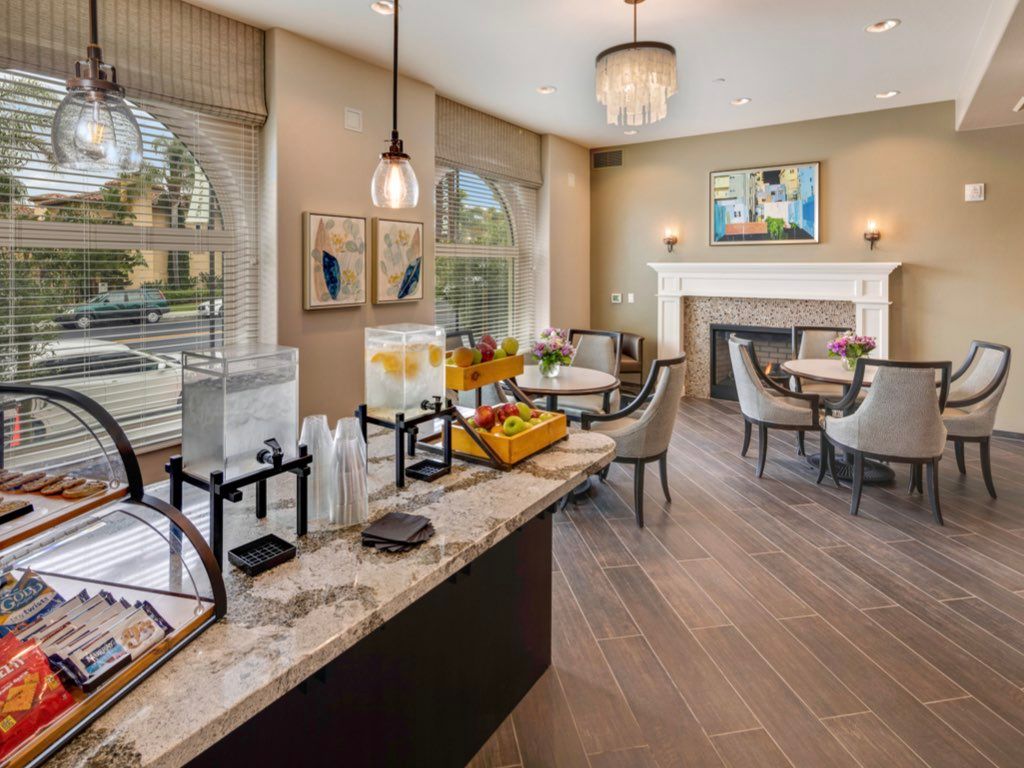A cozy dining area with a breakfast buffet and elegant furnishings.