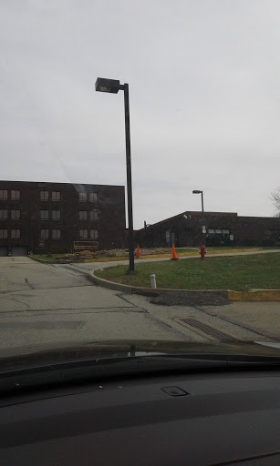 A view of a large building along a winding road on a cloudy day.