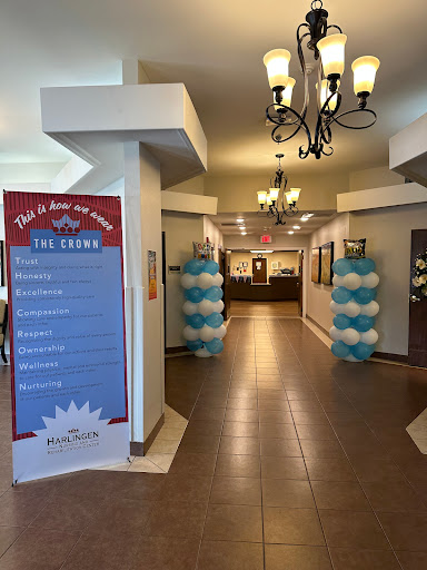 A welcoming lobby adorned with blue and white balloons, featuring a sign that lists upcoming events.