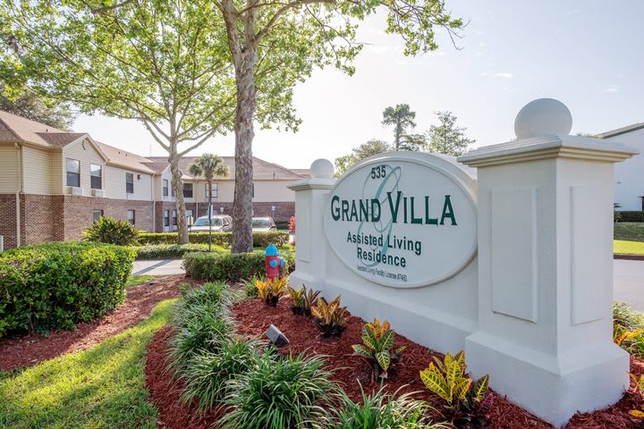 Grand Villa Assisted Living Facility with landscaped entrance.