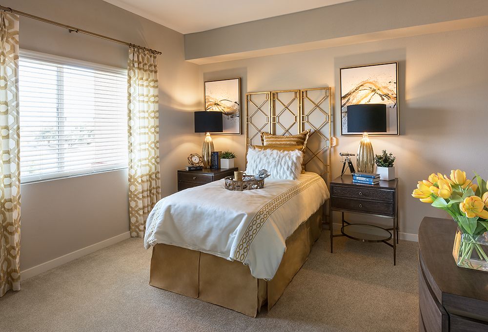 A cozy and elegantly designed bedroom with a single bed, soft lighting, and warm decor accents.