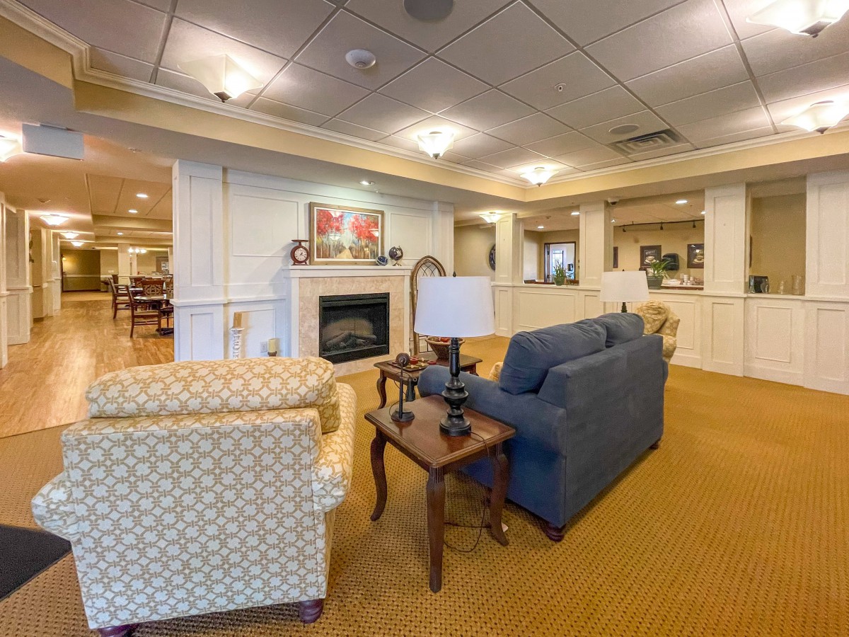 A cozy living room with comfortable seating, a fireplace, and warm lighting.