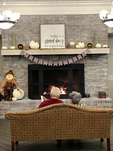 A cozy evening by the fireplace, surrounded by autumn decorations and warmth.