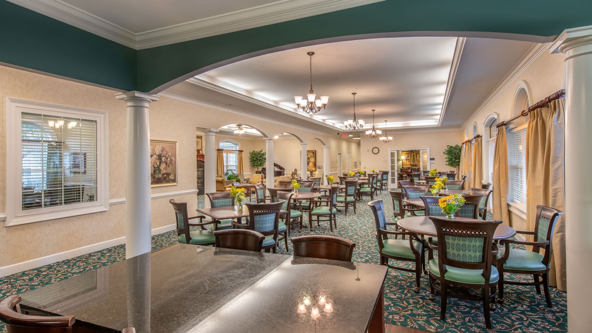 Elegant dining room with set tables and classic decor.