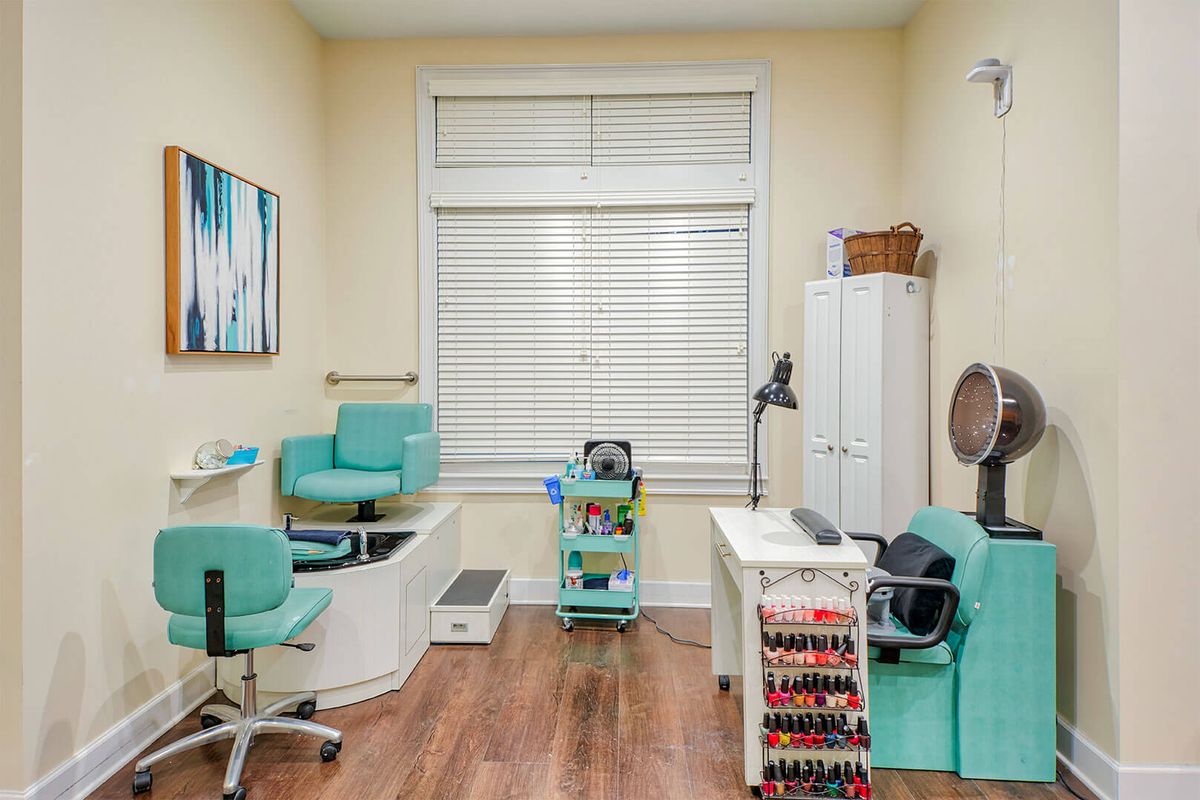 A cozy nail salon with manicure and pedicure stations, featuring a stylish interior design.