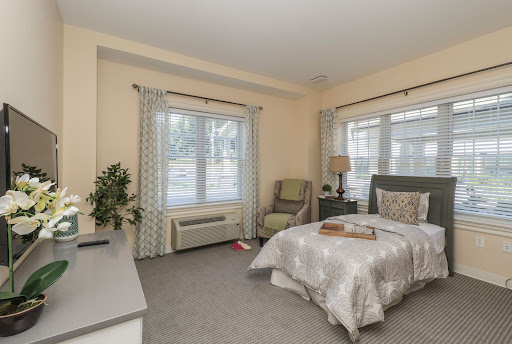 A cozy and well-lit bedroom featuring a comfortable bed, stylish furniture, and natural light from the windows.