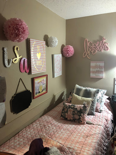 A cozy and colorful bedroom filled with fun wall art and decorative elements.