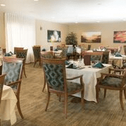 An elegantly decorated dining room with neatly arranged tables and chairs.