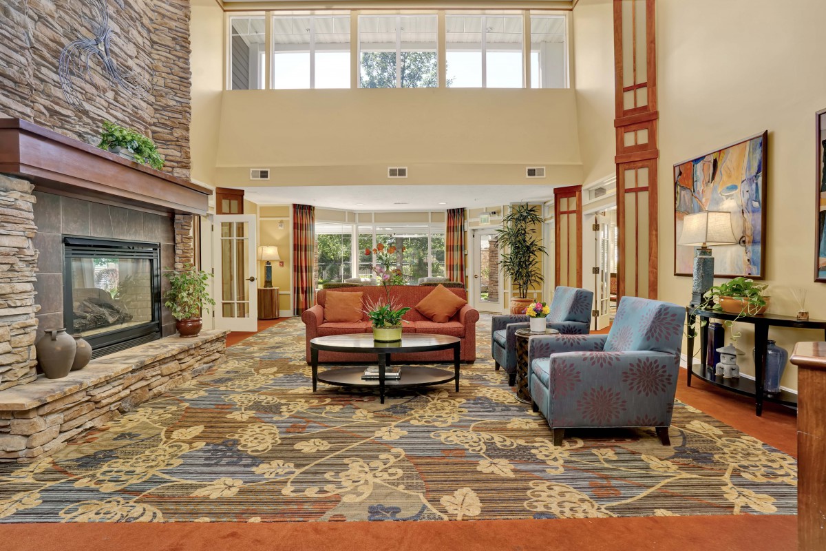 A spacious hotel lobby with comfortable seating and modern decor.