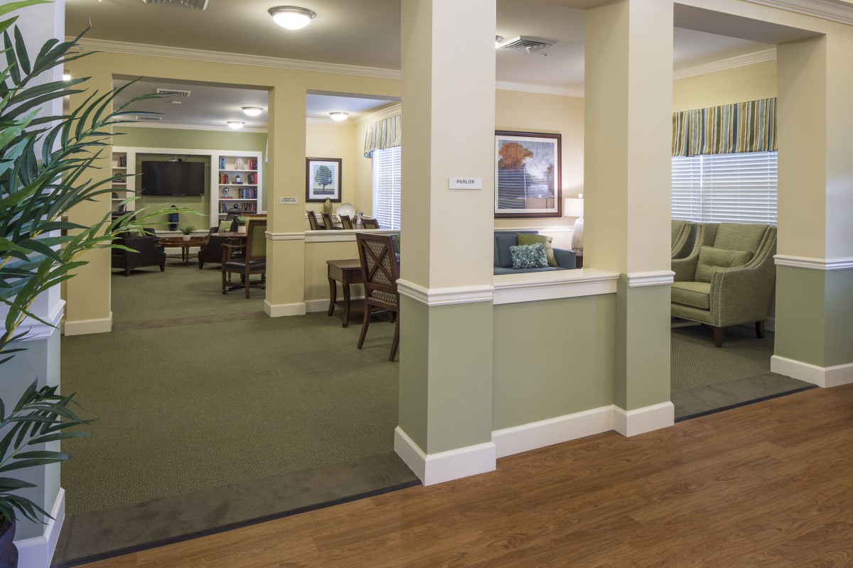 A cozy lounge area decorated with comfortable seating and wall art.