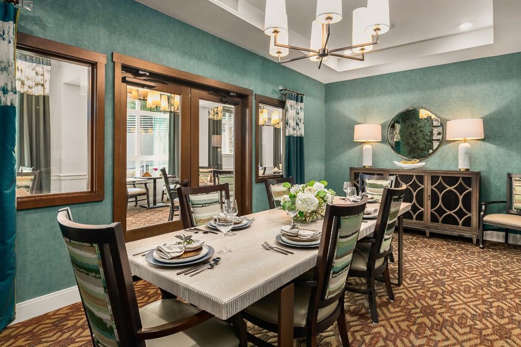 An elegantly designed dining room with a well-set table and stylish decor.